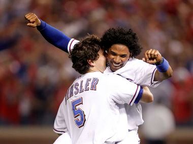 Texas Rangers Ian Kinsler (5) and Elvis Andrus (1) celebrate a victory over the New York...