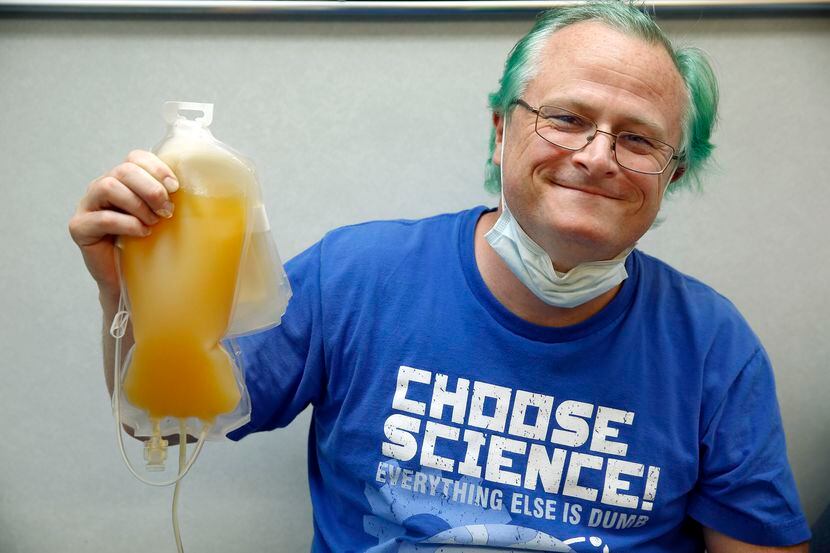 Matt Burnside (left) of Dallas is proud of his 650ml plasma donation at a mobile Carter...