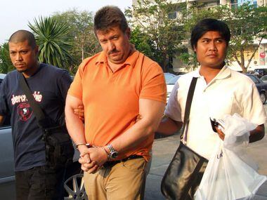 Thai security officers escort suspected Russian arms dealer Viktor Bout at the head of the...