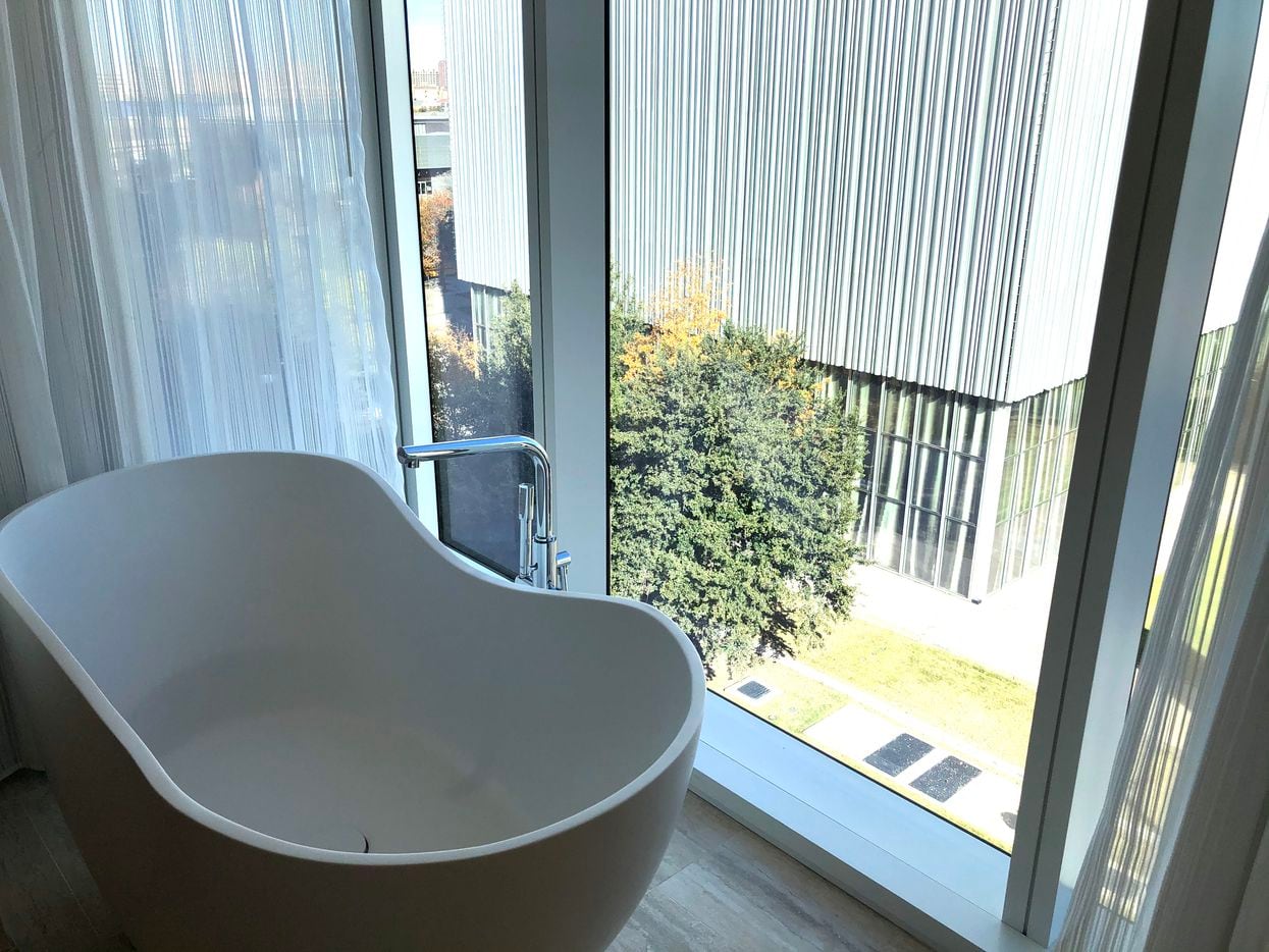 The bathtub in the room has a view of the Arts District.