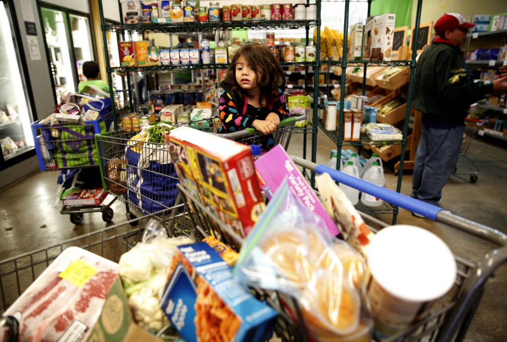 Daenelly Rodriguez waited for her mother as she shopped in the food pantry at the Allen...