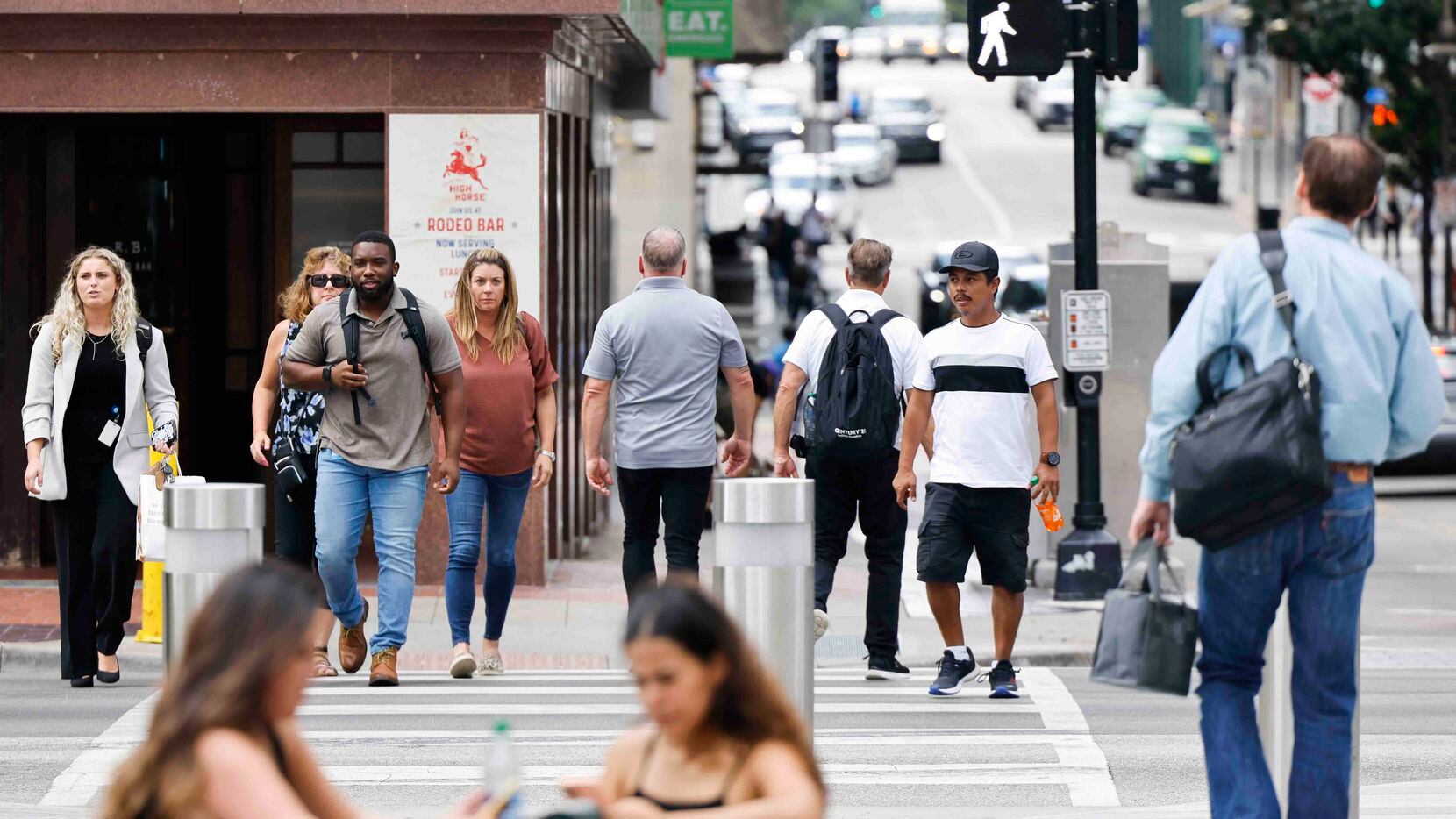 People cross Commerce St. in downtown Dallas on Wednesday, Aug. 24, 2022. 