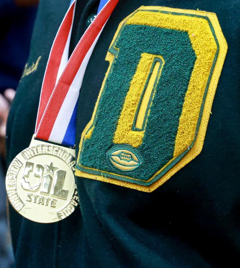 A DeSoto High School football player wears his State Championship medal, Saturday, Jan. 21,...
