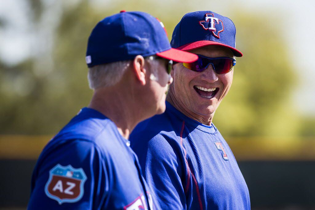 Texas Rangers manager Jeff Banister laughs with Triple-A hitting coach Jim Presley during a...