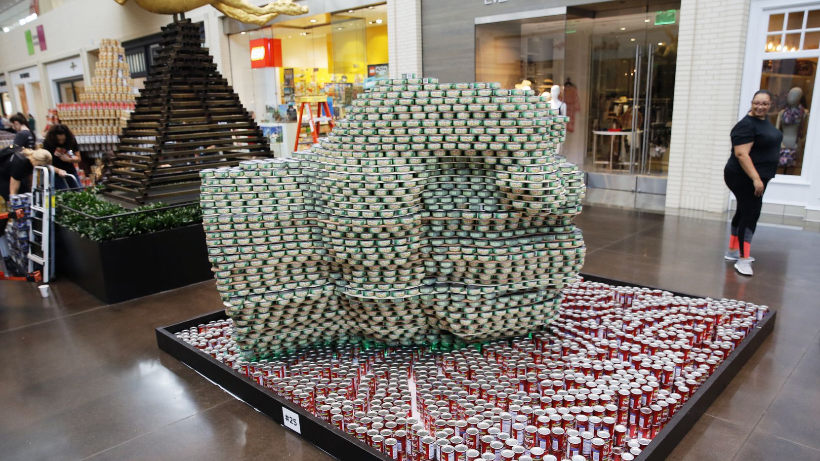 Marcia Johnson of Ridgemont Commercial Construction takes one last look at the "Hulk's Hand" the team built with Boka Powell during Canstruction at NorthPark Center in September.