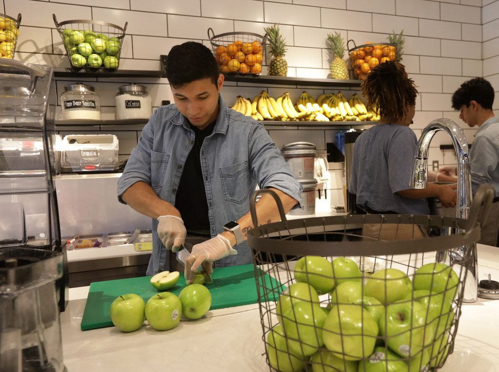Jonathan Olivera cuts some apples at Original Chop Shop in Plano, TX, on Jun. 13, 2019....