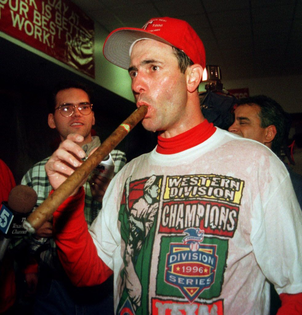 9/28/96---Rangers first baseman Will Clark  takes a hit the victory cigar in the champagne...