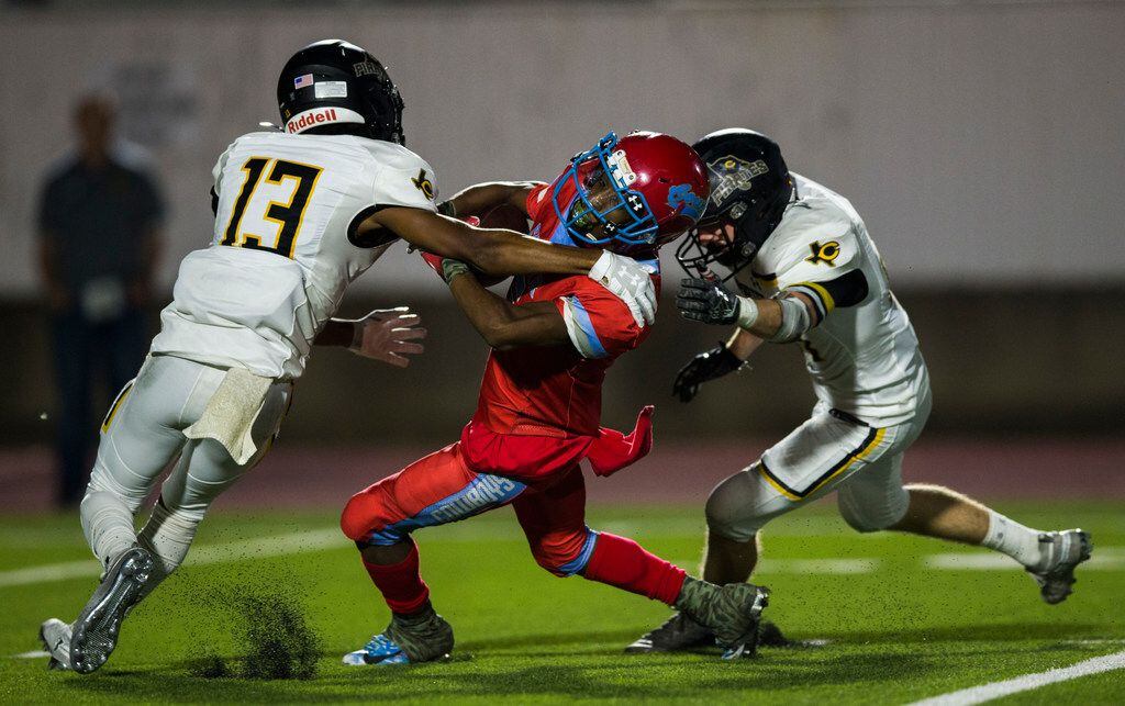 Carter wide receiver Tailon Garrett (5) is tackled by Crandall defensive back Seth Johnson...