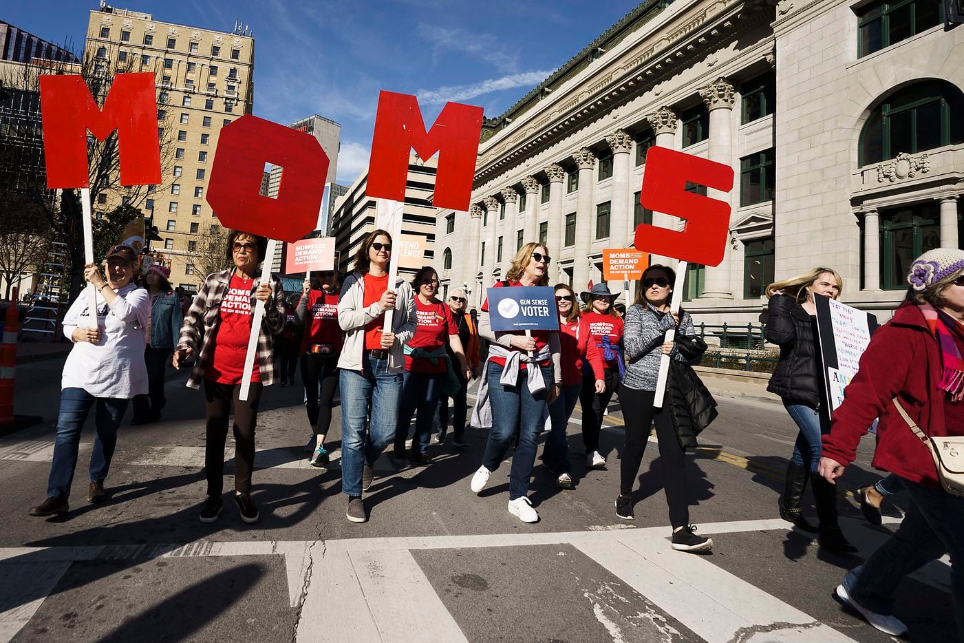 Participants in the 2020 Dallas Women's March walk along Harwood Street on their way to a rally at Dallas City Hall on Sunday, Jan. 19, 2020, in Dallas.