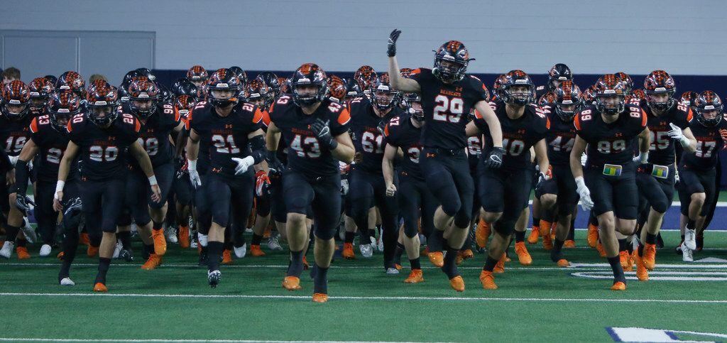 Aledo Bearcats players storm the field just prior to the opening kickoff of their game against Ennis. The two teams played their Class 5A Division ll Regional final playoff football game at Frisco Center at The Star in Frisco on December 6, 2019. (Steve Hamm/ Special Contributor)