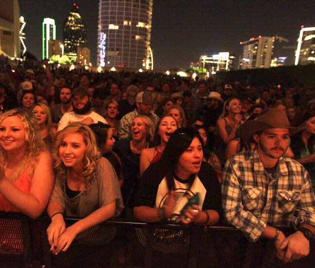Fans cheer at a concert performed at Annette Strauss Artist Square in Dallas. 