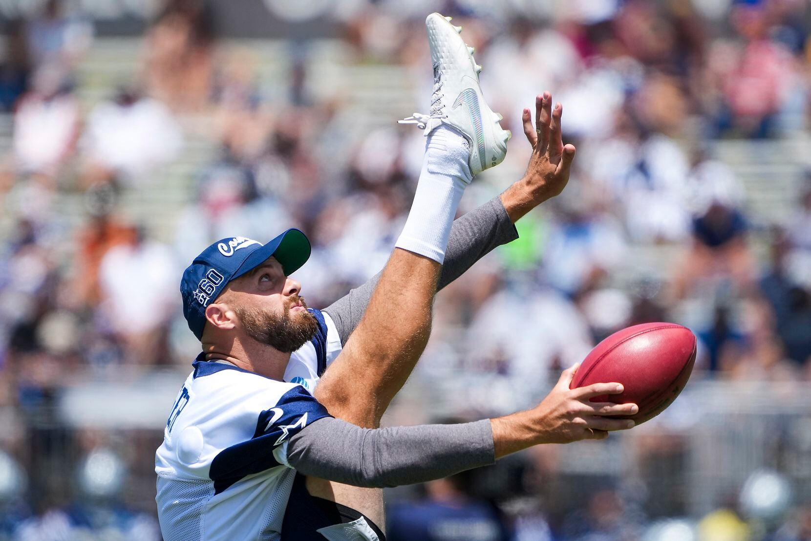 Dallas Cowboys punter Bryan Anger stretches during the first practice of the team’s training...