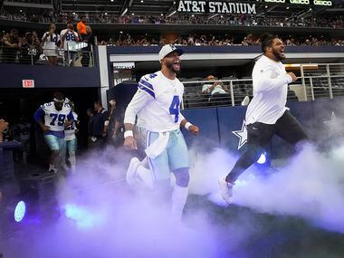 Dallas Cowboys quarterback Dak Prescott (4) and offensive tackle La'el Collins takes the field before a preseason NFL football game against the Jacksonville Jaguars at AT&T Stadium on Sunday, Aug. 29, 2021, in Arlington. (Smiley N. Pool/The Dallas Morning News)