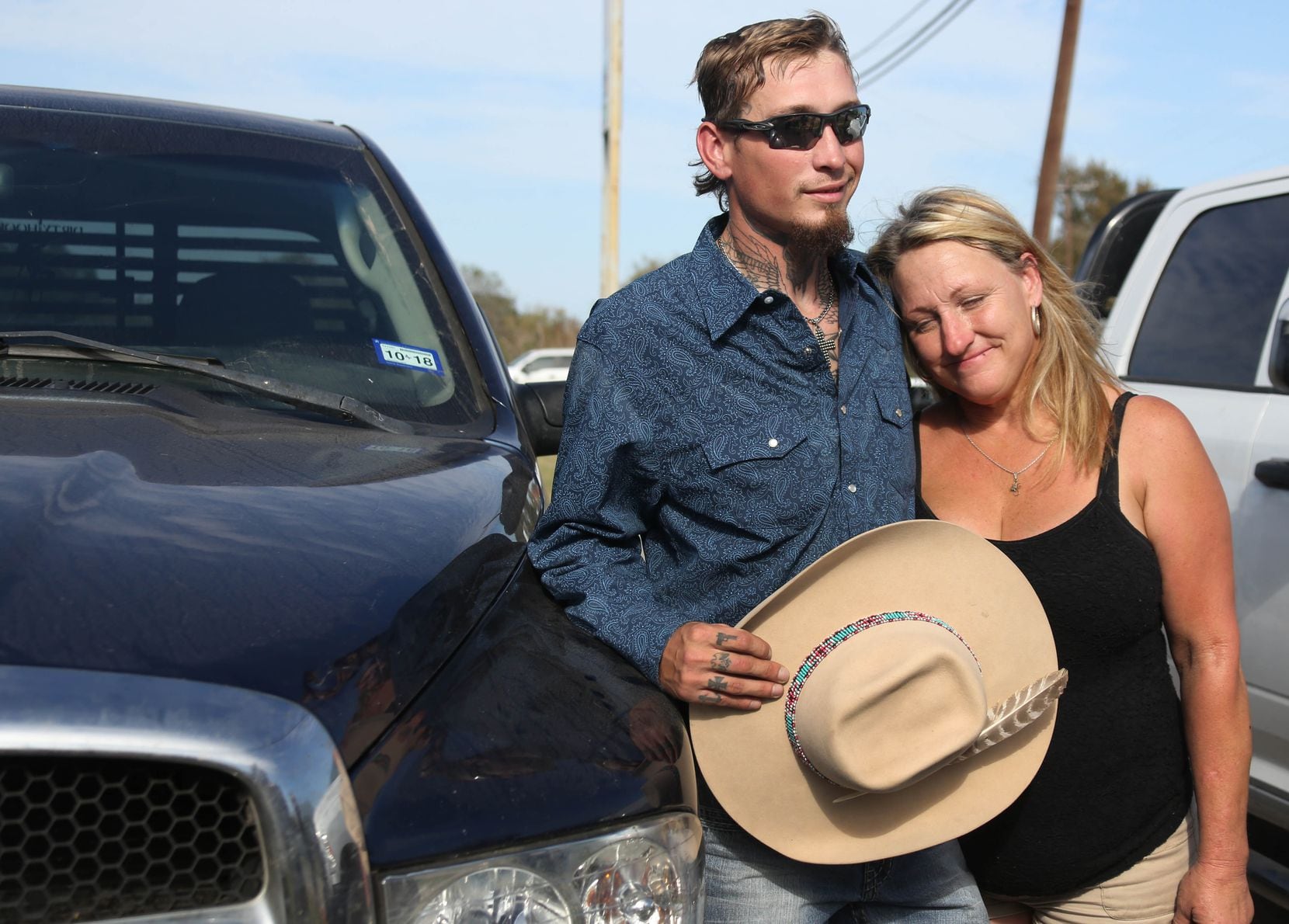 Johnnie Langendorff poses for a photo with his mother Heather Langendorff by the truck he used during a high speed pursuit of the Sutherland Springs Baptist Church gunman after the killing rampage at the church in Sutherlnd Springs, Texas. 