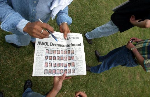 Texas state Democratic representatives held a copy of the Austin American-Statesman on May...