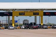 Travelers wait to pay at the north exit toll plaza at DFW International Airport, Friday,...