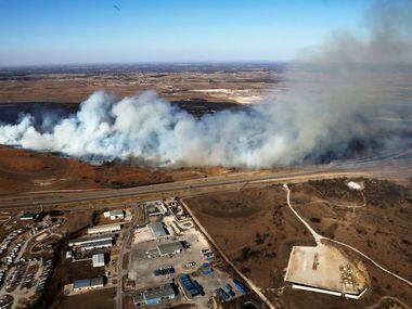 Fire crews tried to control a grass fire west of Fort Worth on Jan. 22, 2018. A massive...