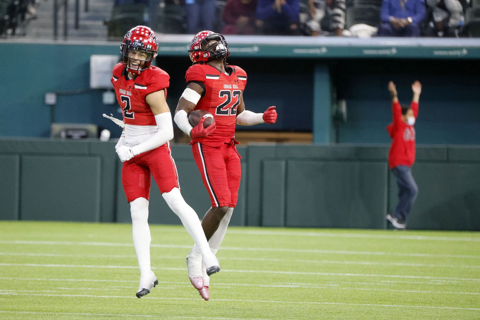 Cedar Hill players Jalon Peoples (2) and Kylan Salter (22) celebrate after Salter recovered...