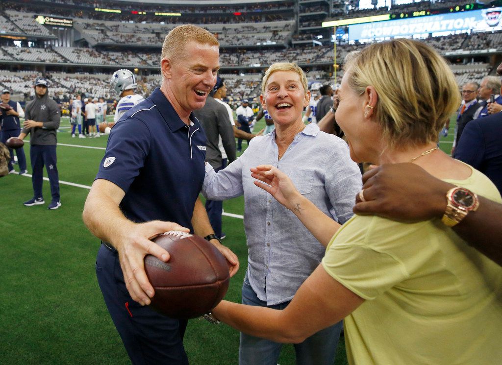 Dallas Cowboys head coach Jason Garrett hugs Portia de Rossi as her spouse Ellen DeGeneres...