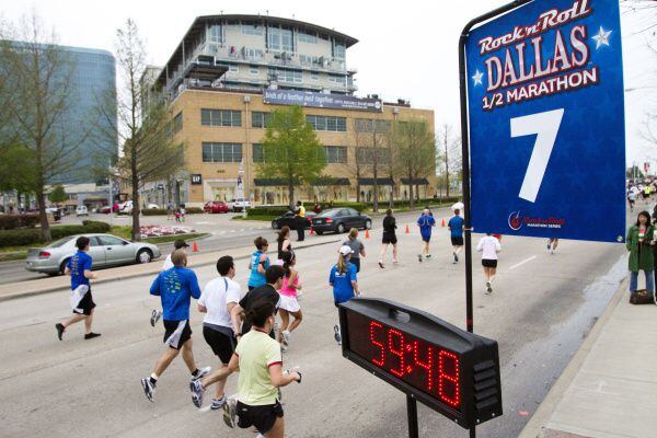 Runners in the Rock 'n' Roll Dallas half-marathon pass Mockingbird Station.