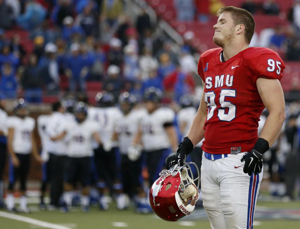 Southern Methodist Mustangs defensive lineman Andrew McCleneghen (95) reacts to the...