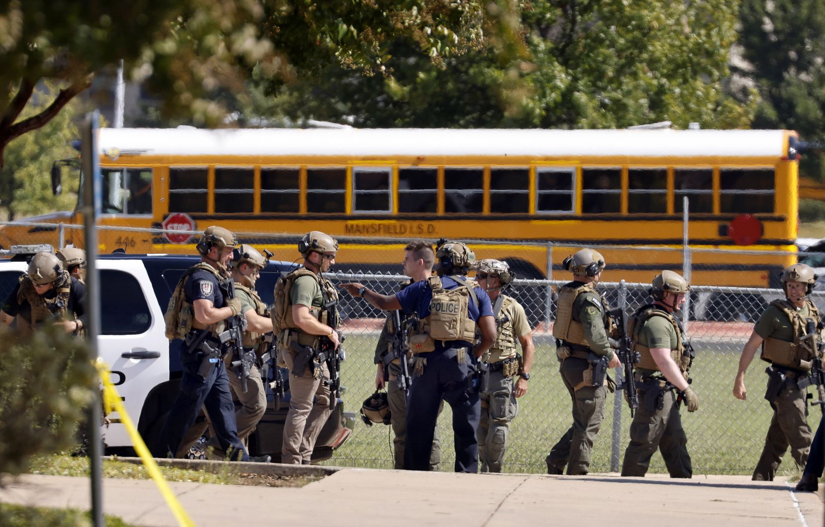 Tactical officers clear the scene following a shooting inside Mansfield Timberview High School in Arlington, Texas, Wednesday, October 6, 2021. Four people were injured in the shooting and the suspect turned himself into the Arlington police. (Tom Fox/The Dallas Morning News)