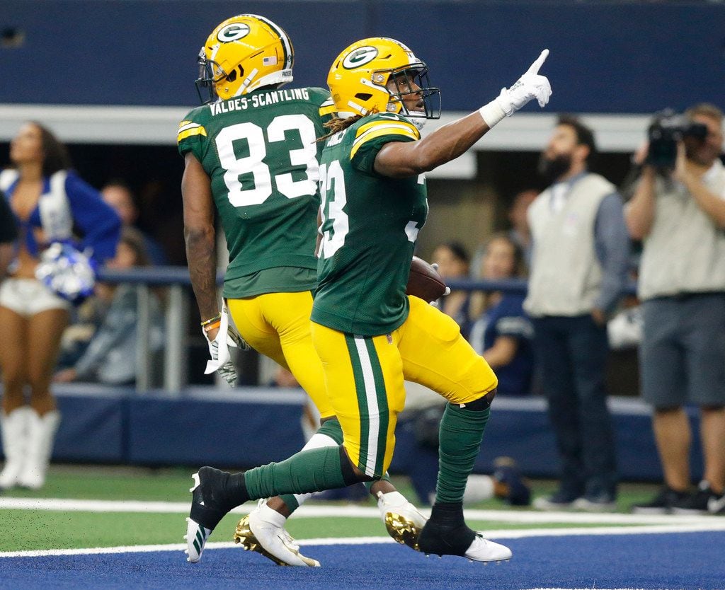 Green Bay Packers running back Aaron Jones (33) scores a first quarter touchdown against the...