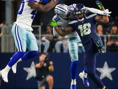 Dallas Cowboys safetys Tyler Coyle (31) and Juanyeh Thomas (40) break up a pass intended for...