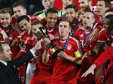 Moroccan King Mohammed VI hands over the trophy to Bayern's team captain Philipp Lahm after...