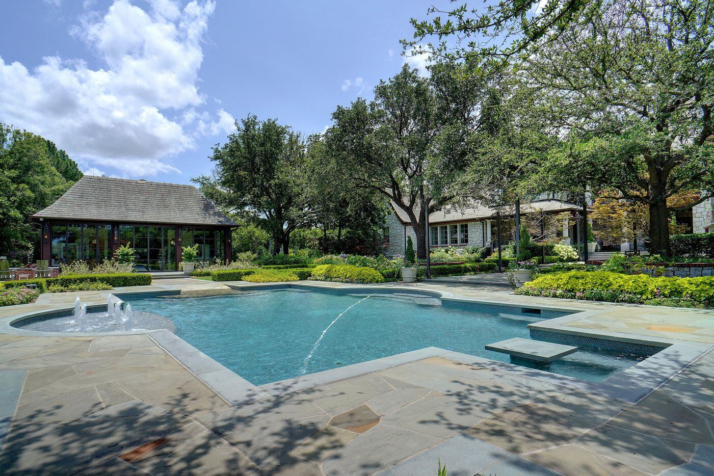 The property at 6401 Westcoat Drive in Colleyville has an abundance of outdoor entertaining areas from a pool and a spa to a cabana, putting green and greenhouse.