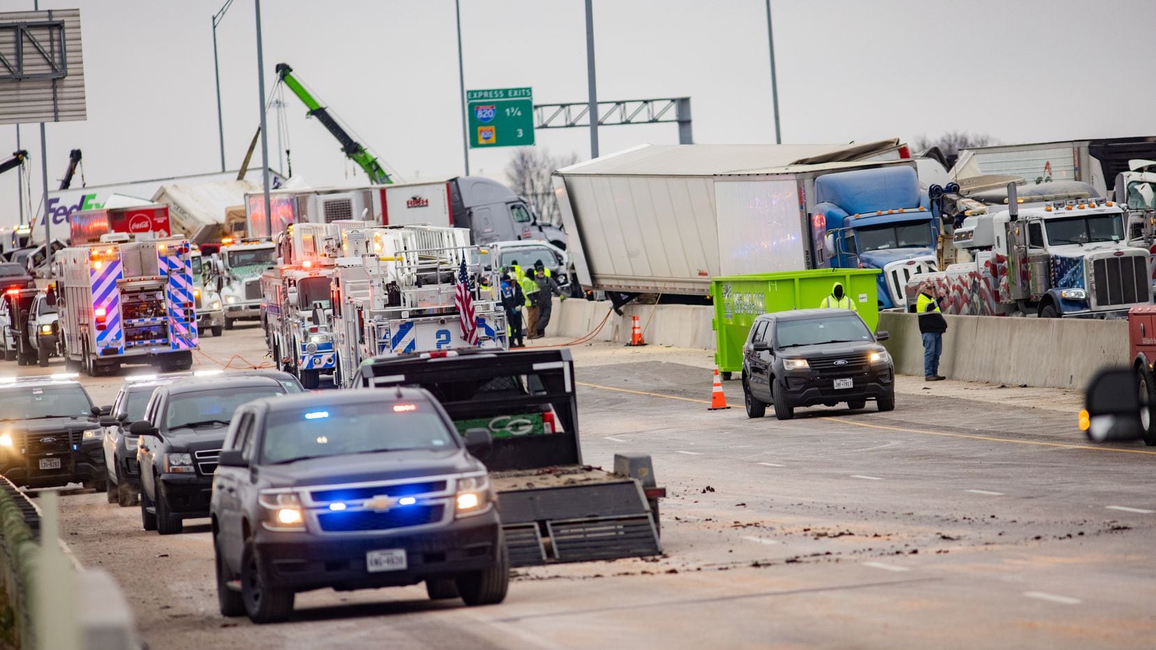 Emergency crews work to clear the mass casualty pile-up on I-35W and Northside Drive in Fort...
