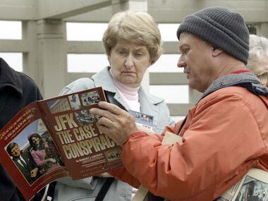 Vendor Fred Browning, right, shows tourist Nancy Sumrall, from Cedar Park, Texas, a...