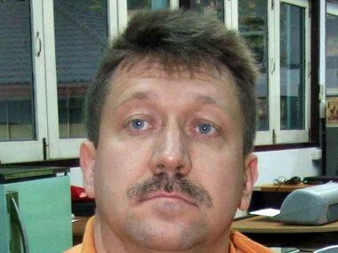 Suspected Russian arms dealer Viktor Bout sits at the head of the Crime Suppression Bureau...