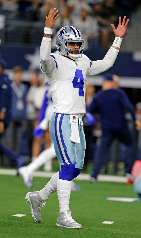 Dallas Cowboys quarterback Dak Prescott (4) raises his hands in approval during during...