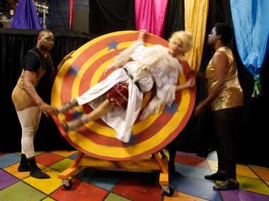 Kim Borge Swarner (Fastrada) is spun on a wheel by actors Rodney M. Morris (left) and Ania...