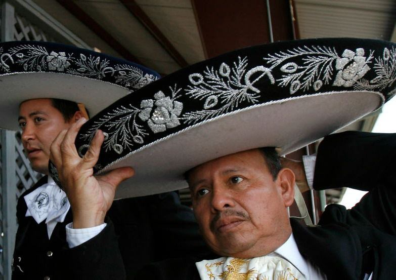 Serafien Salas of Mariachi 90 adjusts his sombrero before going on stage.  