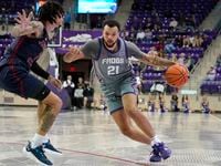 TCU forward JaKobe Coles (21) drives against Jackson State forward Trace Young (3) during...