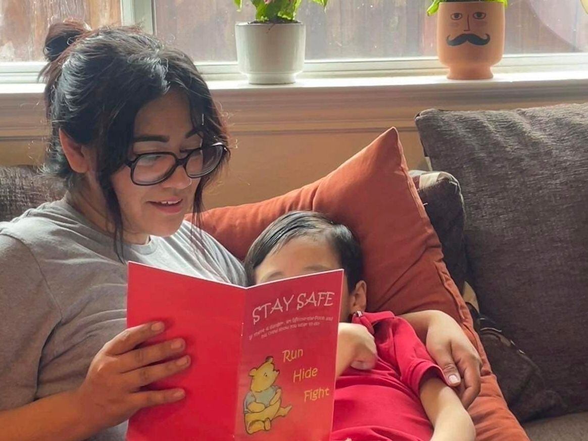 Cindy Campos reads "Stay Safe" to her 5-year-old son in Dallas. (Cindy Campos via AP)