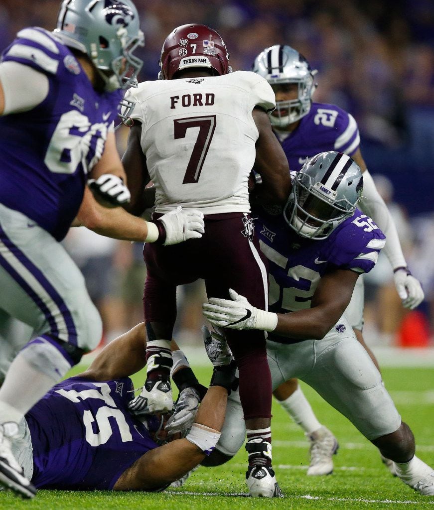 Kansas State defenders do what they can to slow Texas A&M running back Keith Ford (7) in the...