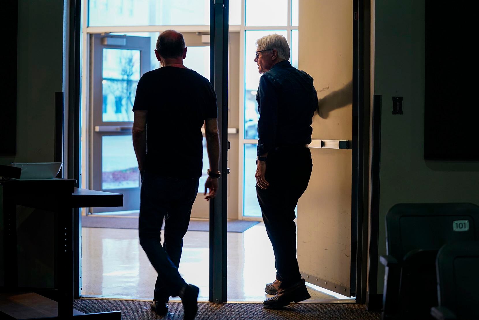 Architect and TJ grad Craig Melde (right) departs a community meeting about the future of...