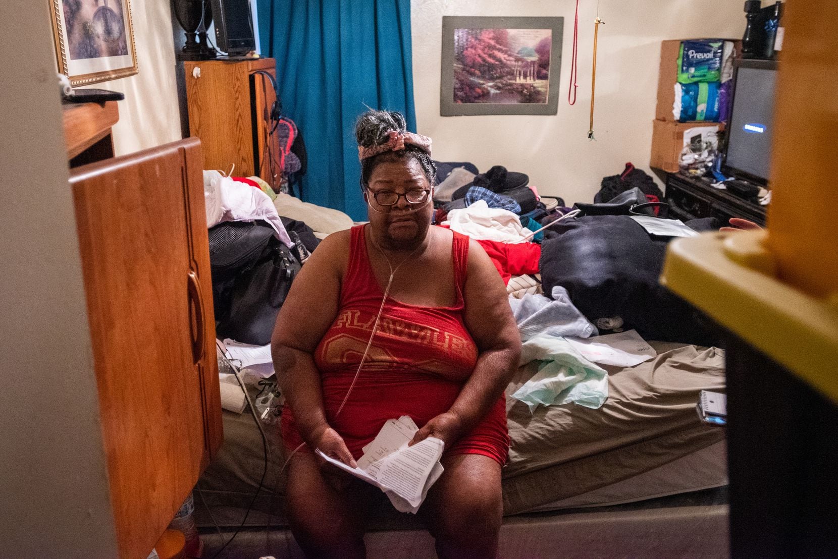 Theresa Smith, using an oxygen machine, sits in her bedroom at the Hillcrest apartments in...