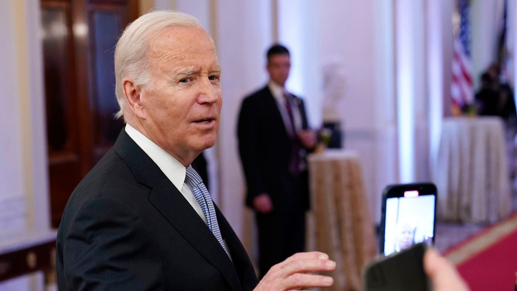 FILE - President Joe Biden talks with reporters after speaking in the East Room of the White...