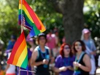 Rainbow flags and an American flag flew during the 2016 Alan Ross Texas Freedom Parade,...