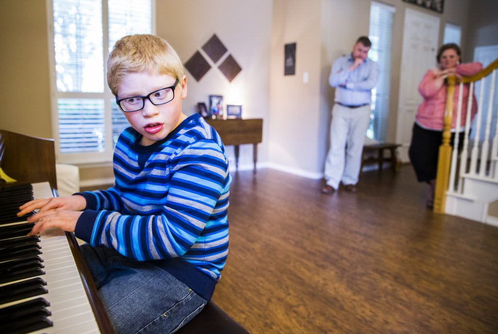 Ben Schneider, 11, plays Ben Folds' "Sky High" on piano in his home while his parents, Rob...