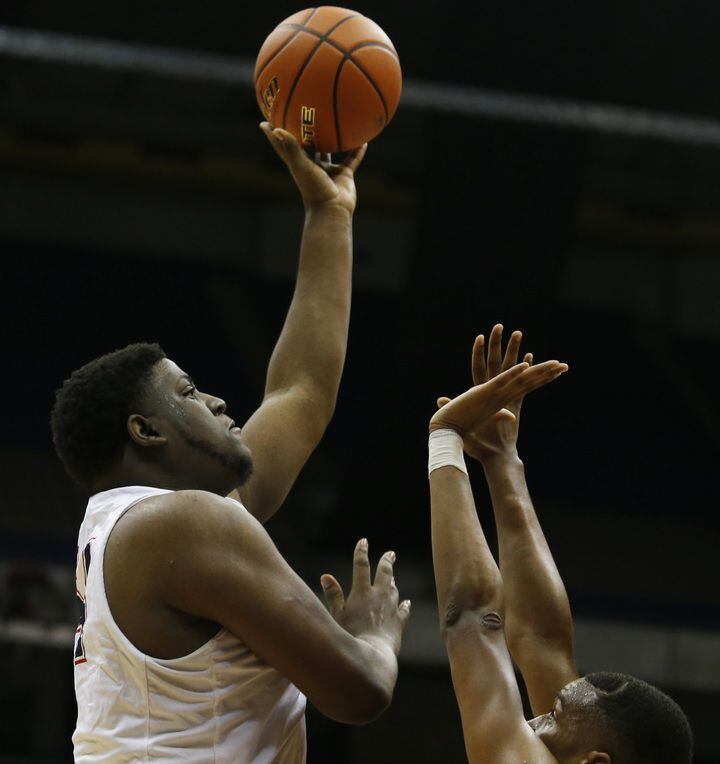 Justin Northwest's Darrell Simpson (left) looks to shoot against Fort Bend Marshall during...