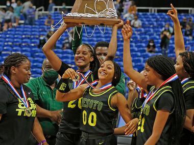 DeSoto Ayanna Thompson #20 holds up their trophy. DeSoto vs. Cypress Creek girls basketball...