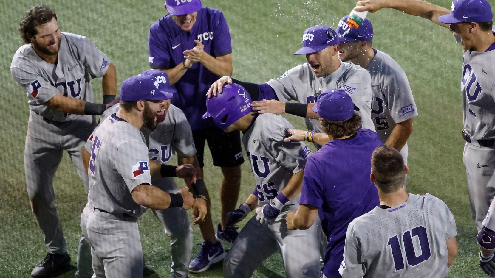 TCU infielder Brayden Taylor (55) is mobbed by teammates after he hit a solo home run...