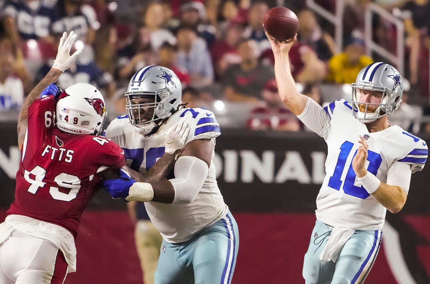 Dallas Cowboys quarterback Cooper Rush (10) throws a pass as tackle Josh Ball (76) blocks against Arizona Cardinals linebacker Kylie Fitts (49) during the second quarter of an NFL football game at State Farm Stadium on Friday, Aug. 13, 2021, in Glendale, Ariz.