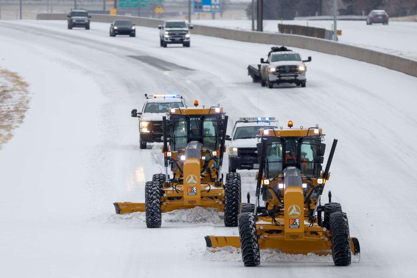 A pair of snowplows clear westbound I-20 in Arlington on Thursday, Feb. 3, 2022. North and...