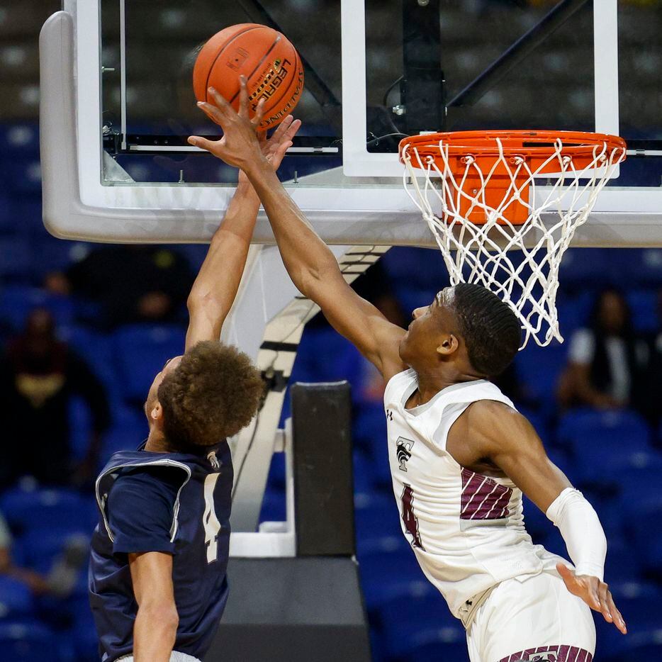 Mansfield Timberview guard Donovan O'Day (4) blocks a layup attempt from Boerne Champion...